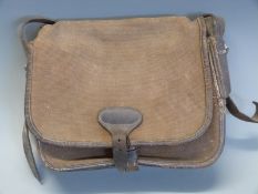 A canvas and leather shotgun cartridge bag.