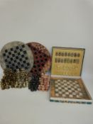 Three various chess sets comprising two carved hardstone examples and one with cast metal Roman
