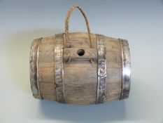 A wooden metal bound gunpowder barrel with WHC carved to both ends,