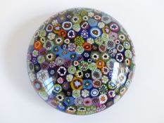 Clichy style close packed millefiori glass paperweight with various multi-coloured and pink,
