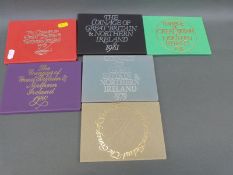 Six brilliant uncirculated Royal Mint UK and Northern Ireland coin sets for 1973, 1975, 1976, 1979,