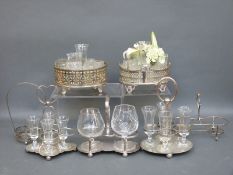 Seven various silver plated cruet or bottle stands and glasses