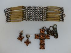 A Butler & Wilson necklace in the form of a cross set with copper coloured stones with matching