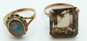 A 9ct gold ring set with a large emerald cut smoky quartz and a 9ct gold ring set with an opal