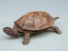 A vintage clockwork tortoise desk bell operated by pressing the head or tail, impressed GSS to base,