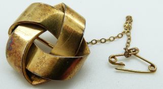 A Victorian yellow metal knot brooch