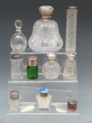 Ten hallmarked silver topped dressing table bottles including a large Victorian cut glass pear