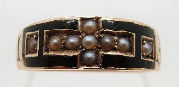 A Victorian mourning ring set with black enamel and seed pearls reading 'In memory of' around the