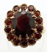 A 9ct gold ring set with garnets in a large cluster, size M/N, 5.