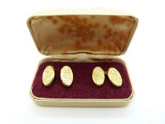 A pair of 9ct gold cufflinks with engraved foliate design, in original box, 3.