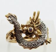 A 9ct gold ring set with a rotating dragon set with diamonds chasing a ruby representing a flaming