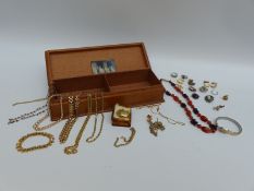 A collection of costume jewellery to include a camelian and garnet necklace, badges,