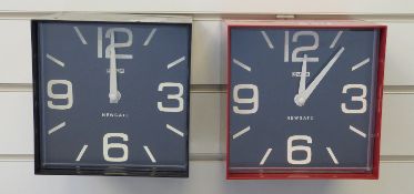 Two Newgate quartz 'cube clocks', one in red, one in black finish, both with black Arabic dials,