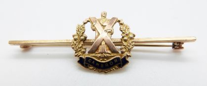 A 9ct gold pin for the Queens Own Cameron Highlanders