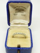 A platinum eternity ring set with round cut diamonds in original box, size K, 0.