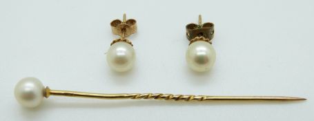 A gold stick pin set with a pearl and a pair of 9ct gold earrings set with pearls