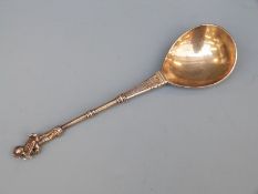 Possibly Dutch gilt white metal apostle spoon surmounted with a figure holding a cross,
