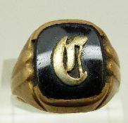 A yellow metal signet ring marked 10k set with black onyx, size T, 5.
