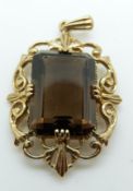 A 9ct gold pendant set with an emerald cut smoky quartz, 6.
