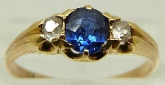 A Victorian ring set with a sapphire and two old cut diamonds, size J/K, 2.