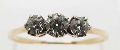 An 18ct gold ring set with three diamonds, the centre stone approximately 0.15ct, size P, 1.