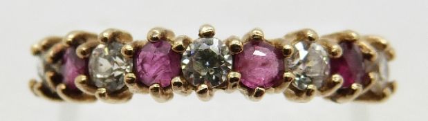 A 9ct gold ring set with alternating rubies and paste, size J, 1.