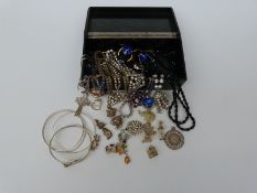 A collection of silver charms including monkeys, diamante necklaces, jet necklace, silver necklace,