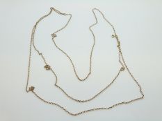 A three strand yellow metal necklace, 9.