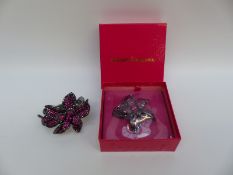 A Butler & Wilson bangle set with purple crystals in the form of a flower with matching brooch in