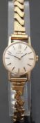 Omega 9ct gold ladies wristwatch with black hands, gold baton markers,