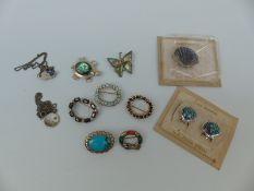 A silver brooch set with abalone in the shape of a shell with matching earrings,