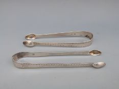 Two sets of Georgian bright cut hallmarked silver sugar tongs both with lion passant,