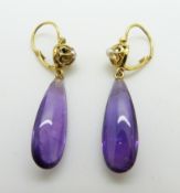 A pair of French earrings set with a elongated amethyst drop and a pearl to each
