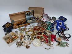 A collection of costume jewellery to include beads, lucite brooch and earrings,