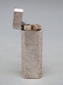 A brushed metal Cartier cigarette lighter