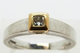 An 18ct white gold ring set with a princess cut diamond in a yellow gold setting, size N, 5.