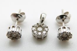 An 18ct white gold pendant and matching earrings each set with a cluster of diamonds