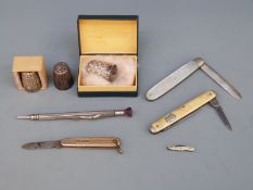 A mother of pearl fruit knife with a hallmarked silver blade, three other fruit knives,