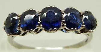 A platinum ring set with five graduating sapphires, the centre sapphire measuring 0.