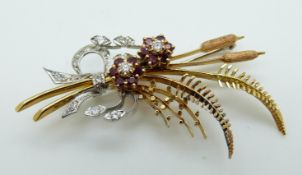A 18ct gold brooch depicting a bouquet of matt bulrushes, ferns,
