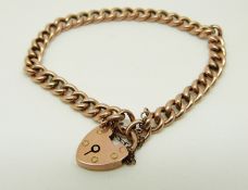 A 9ct rose gold curb link bracelet with heart padlock clasp, 10.