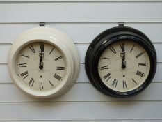 Two Newgate quartz dial wall clocks with Roman numerals, one in black the other mushroom finish,