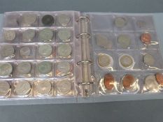 An amateur collection of coins in an album, largely world coins,