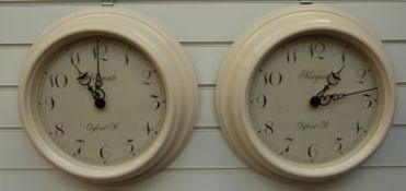 Two Newgate quartz dial wall clocks with Arabic numerals, both in mushroom coloured finish,