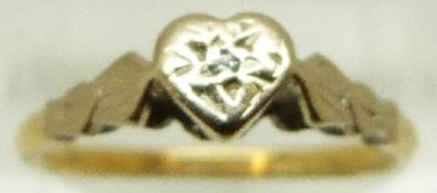 An 18ct gold ring set with a diamond in a heart shaped platinum setting, size Q, 3.