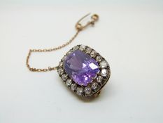 A Victorian brooch set with a cushion cut natural,