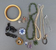A collection of jewellery including jadeite necklace, ivory bangle, jet earrings, jet brooch,