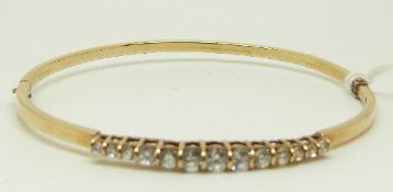 A 9ct gold bangle set with graduated cubic zirconia, 5.