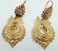 A pair of yellow metal earrings,