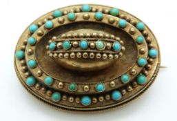 A Victorian mourning brooch set with turquoise cabochons and sphere decoration verso a glass